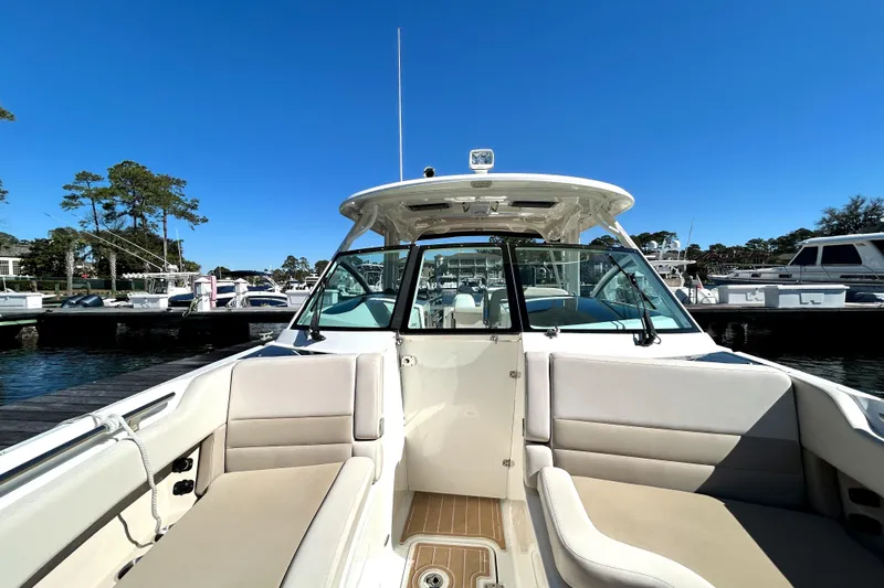  Yacht Photos Pics 2017 Boston Whaler 320 Vantage boat docked at marina under clear blue sky.