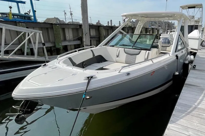 Seaventure Yacht Photos Pics 2023 Chaparral 280 OSX boat docked at marina under clear sky.