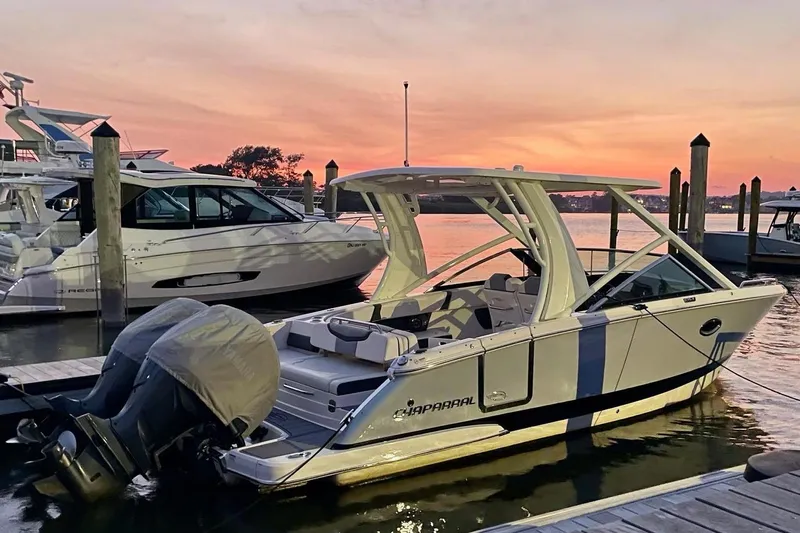 Seaventure Yacht Photos Pics 2023 Chaparral 280 OSX boat docked at sunset, showcasing sleek design and modern features.