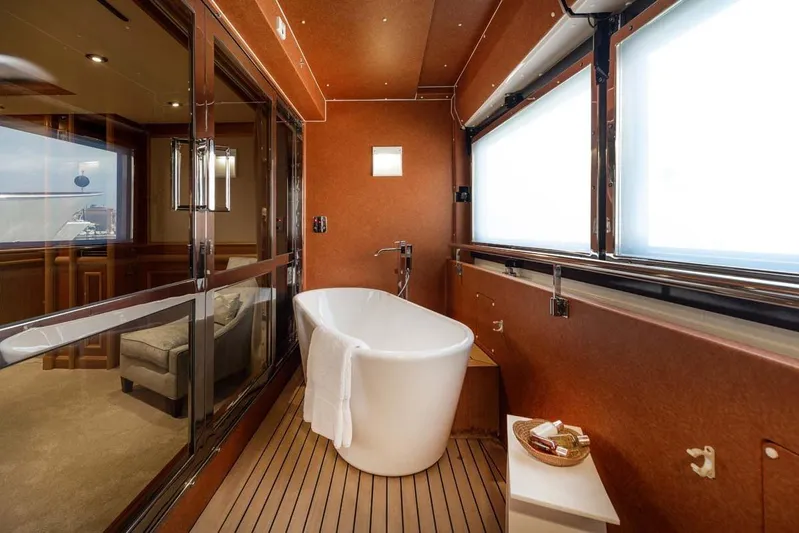 Emotion 2 Yacht Photos Pics Luxurious bathroom with freestanding tub on 2007 CRN Motor Yacht, featuring elegant wood paneling.