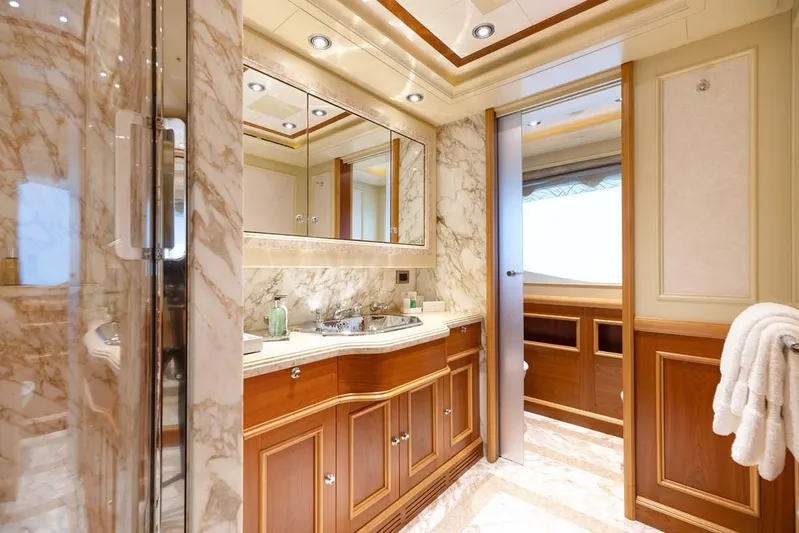 Emotion 2 Yacht Photos Pics Luxurious marble bathroom in 2007 CRN Motor Yacht, featuring elegant wood cabinetry.