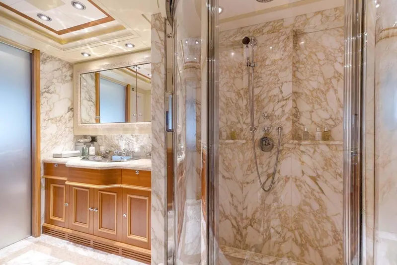 Emotion 2 Yacht Photos Pics Luxurious marble bathroom in 2007 CRN Motor Yacht, featuring elegant wood cabinetry and modern fixtures.