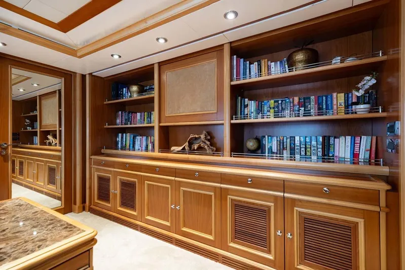 Emotion 2 Yacht Photos Pics Luxurious wooden library interior on 2007 CRN Motor Yacht, featuring bookshelves and elegant decor.