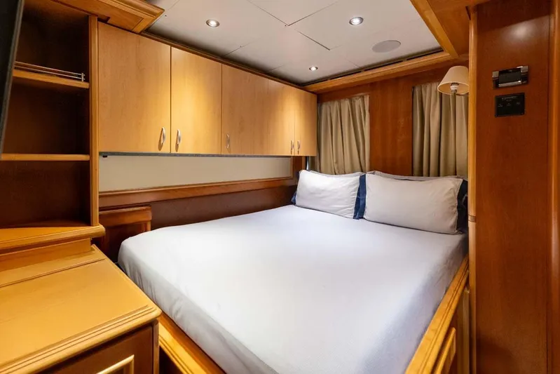 Emotion 2 Yacht Photos Pics Luxurious bedroom interior of 2007 CRN Motor Yacht with wooden cabinetry and cozy bedding.