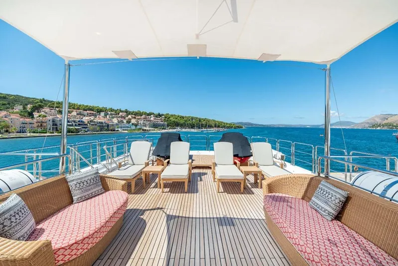 Emotion 2 Yacht Photos Pics Luxurious 2007 CRN Motor Yacht deck with seating, overlooking scenic coastal view.