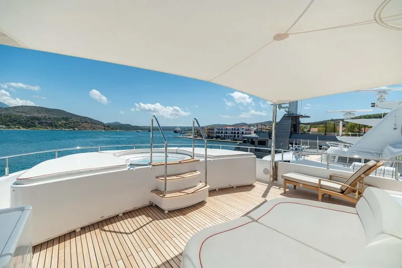 Emotion 2 Yacht Photos Pics Luxurious 2007 CRN motor yacht deck with jacuzzi, sun loungers, and scenic ocean view.