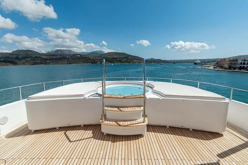 Emotion 2 Yacht Photos Pics Luxurious 2007 CRN Motor Yacht deck with jacuzzi, overlooking serene coastal waters.