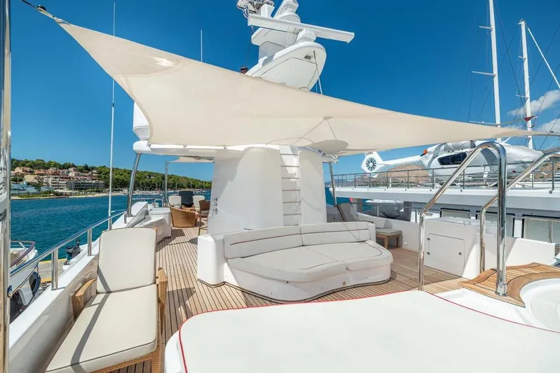 Emotion 2 Yacht Photos Pics Luxurious 2007 CRN Motor Yacht deck with seating, sunshade, and scenic ocean view.