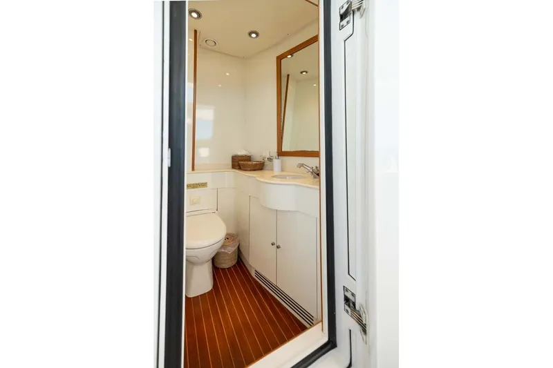 Emotion 2 Yacht Photos Pics Luxurious bathroom on 2007 CRN Motor Yacht with modern fixtures and wooden flooring.