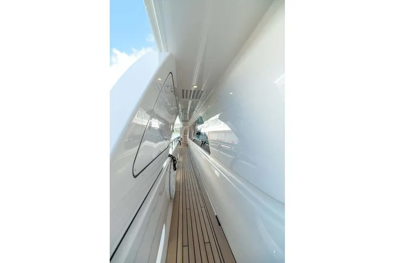 Emotion 2 Yacht Photos Pics Side deck view of 2007 CRN Motor Yacht with sleek white finish and wooden flooring.