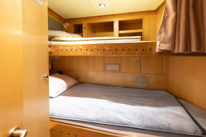 Emotion 2 Yacht Photos Pics Luxurious 2007 CRN Motor Yacht cabin with cozy bunk beds and warm lighting.