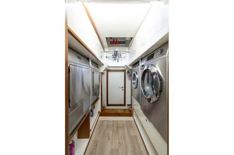 Emotion 2 Yacht Photos Pics Laundry room on a 2007 CRN Motor Yacht with modern appliances and wood accents.