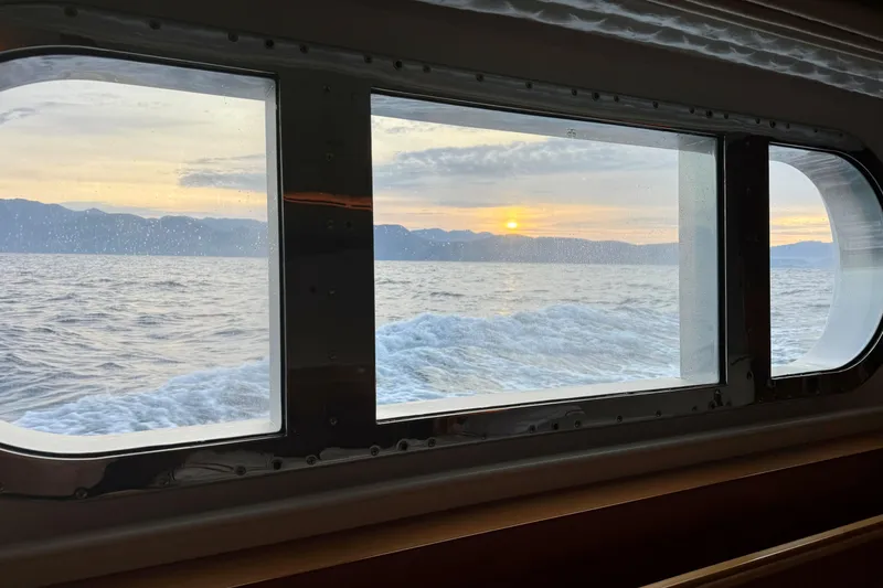 Emotion 2 Yacht Photos Pics View of ocean sunset through CRN Motor Yacht window, 2007 model.