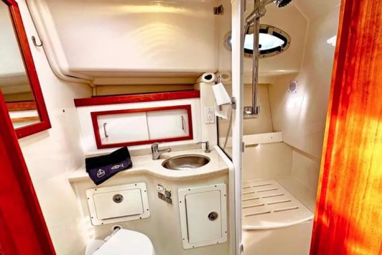 Ha Kin Yacht Photos Pics 2008 Back Cove 33 yacht bathroom with sink, shower, and storage cabinets.