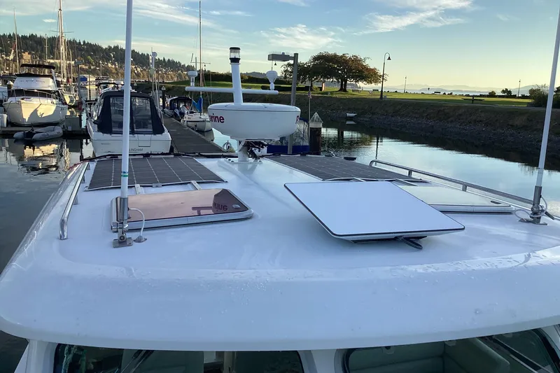 Ha Kin Yacht Photos Pics 2008 Back Cove 33 boat docked, featuring solar panels and radar equipment on the roof.
