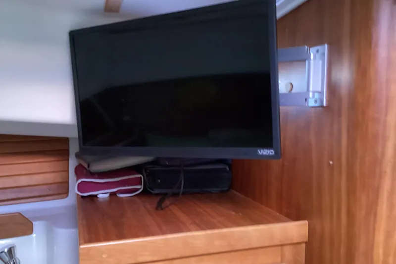Ha Kin Yacht Photos Pics 2008 Back Cove 33 interior with mounted Vizio TV on wooden cabinet.