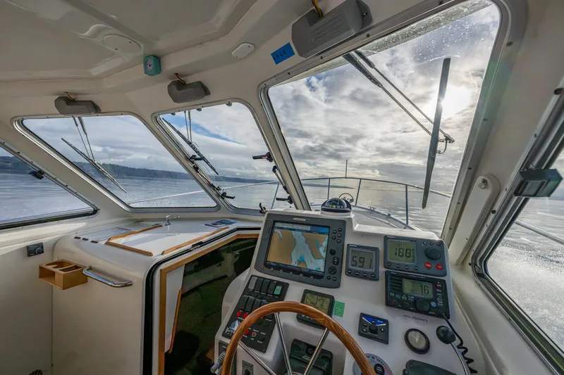 Ha Kin Yacht Photos Pics Interior view of 2008 Back Cove 33 boat cockpit with navigation equipment and scenic water view.