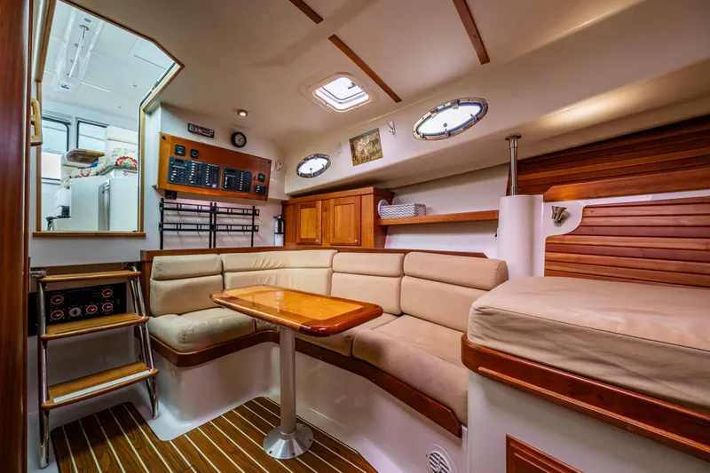 Ha Kin Yacht Photos Pics Luxurious interior of 2008 Back Cove 33 yacht with cozy seating and elegant wood finishes.