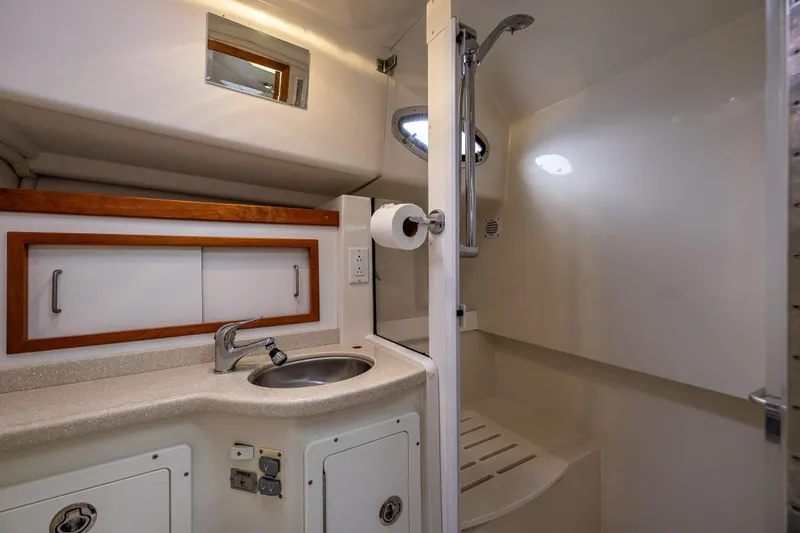 Ha Kin Yacht Photos Pics Luxurious 2008 Back Cove 33 yacht bathroom with sink, shower, and storage cabinets.
