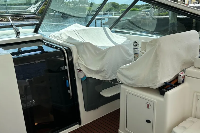  Yacht Photos Pics 2000 Tiara Yachts 3700 Open cockpit with covered seats and helm, docked by the water.