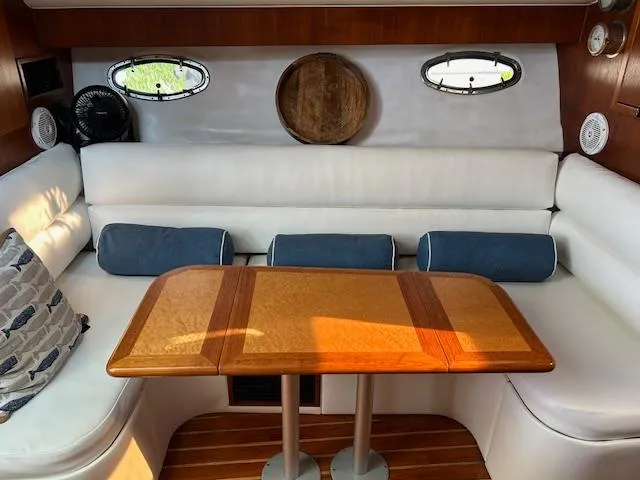  Yacht Photos Pics Interior of 2000 Tiara Yachts 3700 Open with white seating and wooden table.