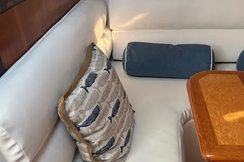  Yacht Photos Pics Interior of 2000 Tiara Yachts 3700 Open with cushions and wooden table.