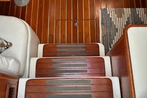  Yacht Photos Pics Wooden steps on a 2000 Tiara Yachts 3700 Open, featuring a striped rug.