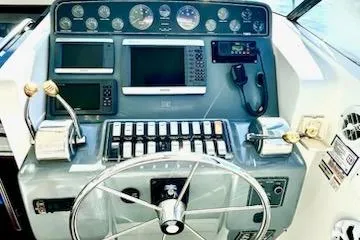  Yacht Photos Pics Control panel of 2000 Tiara Yachts 3700 Open with navigation instruments and steering wheel.