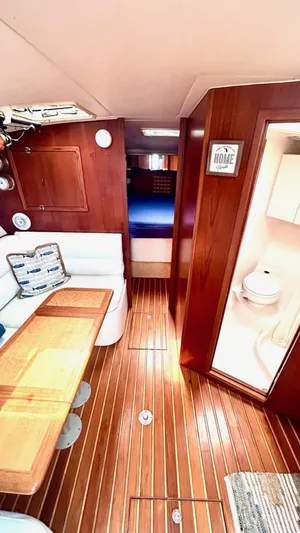  Yacht Photos Pics Interior of 2000 Tiara Yachts 3700 Open, featuring wood paneling and cozy seating area.