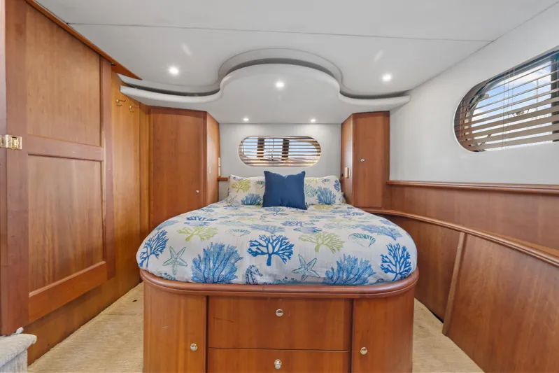 Sunset Chaser Yacht Photos Pics Luxurious 2002 Silverton 43 Motor Yacht bedroom with elegant wood finish and cozy bedding.
