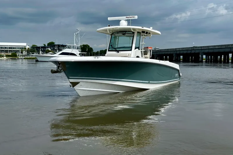 Bottoms Up Yacht Photos Pics 2019 Boston Whaler 330 Outrage boat on calm water under cloudy sky.