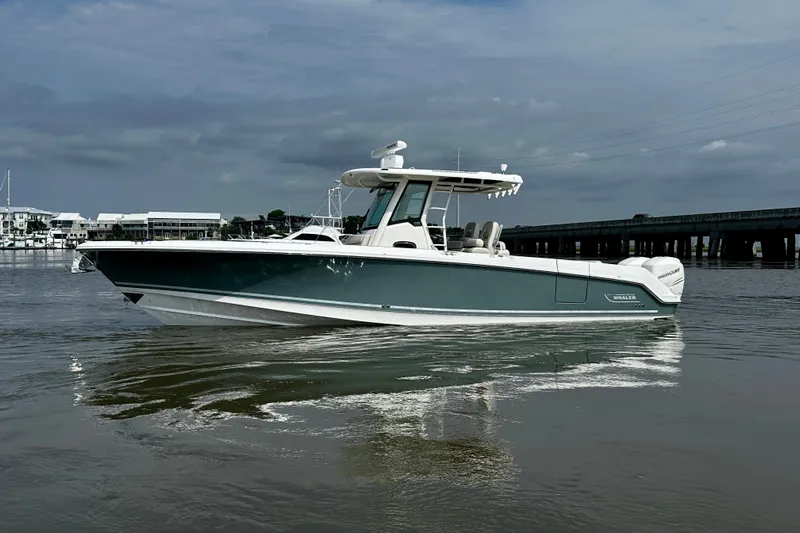 Bottoms Up Yacht Photos Pics 2019 Boston Whaler 330 Outrage boat on calm water under cloudy sky.