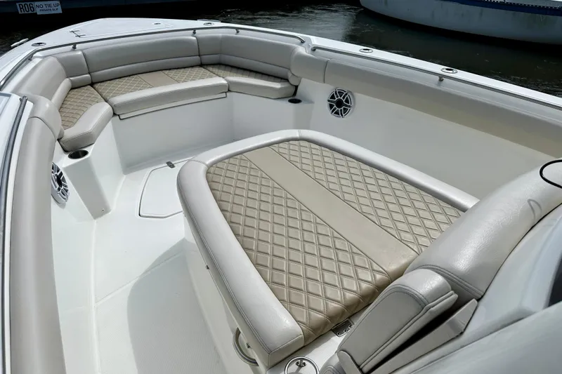 Bottoms Up Yacht Photos Pics 2019 Boston Whaler 330 Outrage boat interior with luxurious seating and diamond-pattern upholstery.