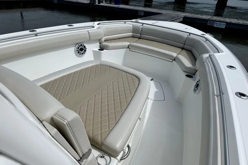 Bottoms Up Yacht Photos Pics 2019 Boston Whaler 330 Outrage boat interior with cushioned seating and speakers.
