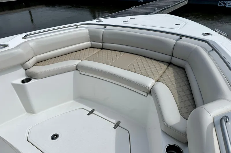 Bottoms Up Yacht Photos Pics 2019 Boston Whaler 330 Outrage boat interior with cushioned seating and cup holders.