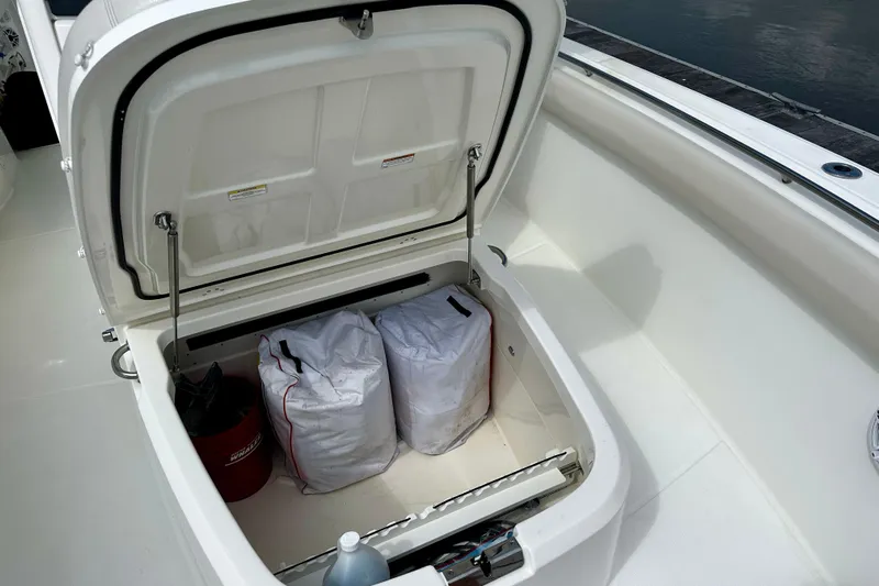 Bottoms Up Yacht Photos Pics Open storage compartment on 2019 Boston Whaler 330 Outrage boat, containing bags and equipment.
