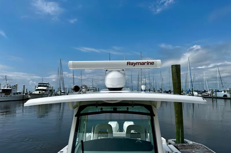 Bottoms Up Yacht Photos Pics 2019 Boston Whaler 330 Outrage with Raymarine radar at marina, under blue sky.