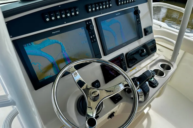 Bottoms Up Yacht Photos Pics 2019 Boston Whaler 330 Outrage helm with dual Raymarine displays and stainless steel steering wheel.