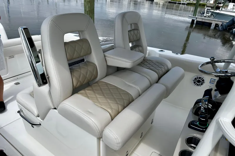 Bottoms Up Yacht Photos Pics 2019 Boston Whaler 330 Outrage helm seating with luxurious upholstery and modern controls.