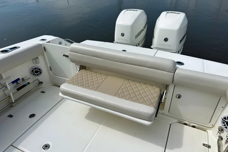 Bottoms Up Yacht Photos Pics 2019 Boston Whaler 330 Outrage boat with cushioned seating and twin Mercury engines.