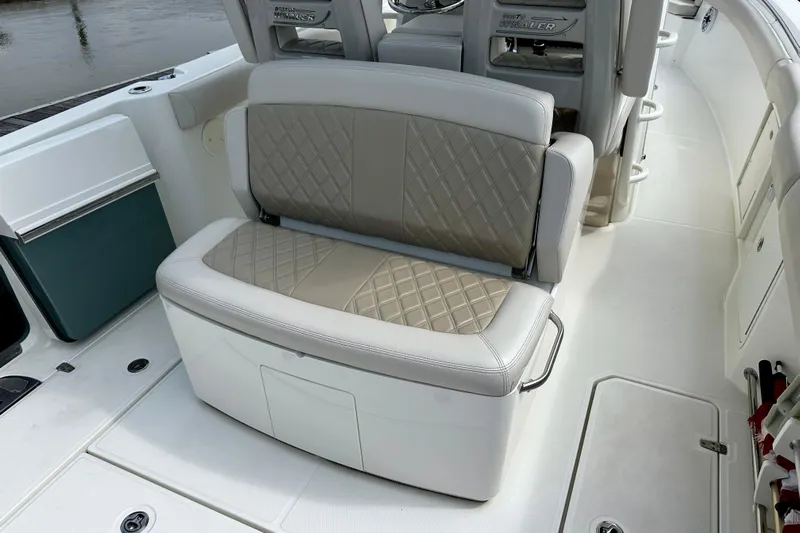 Bottoms Up Yacht Photos Pics 2019 Boston Whaler 330 Outrage boat interior with cushioned seating and storage.