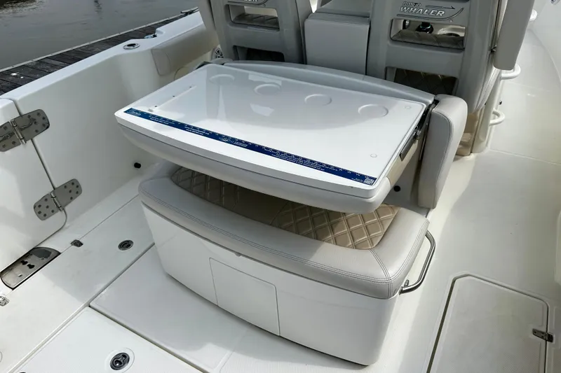 Bottoms Up Yacht Photos Pics 2019 Boston Whaler 330 Outrage interior with foldable seat and storage compartment.