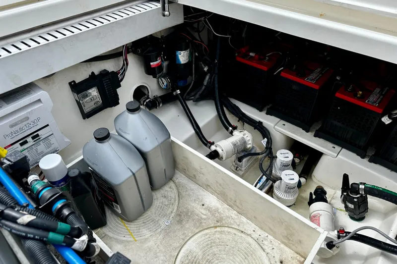 Bottoms Up Yacht Photos Pics 2019 Boston Whaler 330 Outrage engine compartment with batteries and maintenance equipment.
