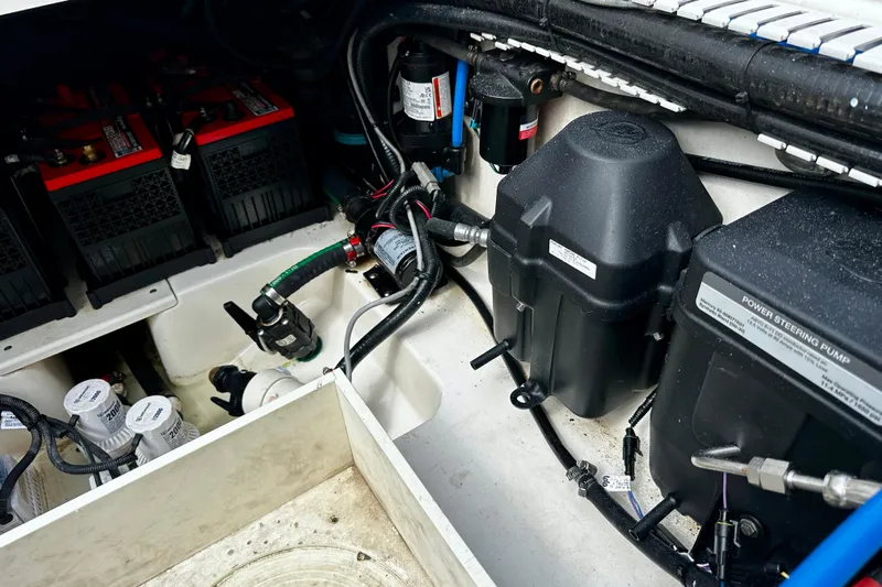 Bottoms Up Yacht Photos Pics Engine compartment of a 2019 Boston Whaler 330 Outrage, showing batteries and power steering pump.