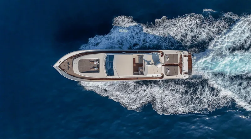  Yacht Photos Pics Aerial view of 1999 Leopard 27 yacht cruising on blue ocean waters.