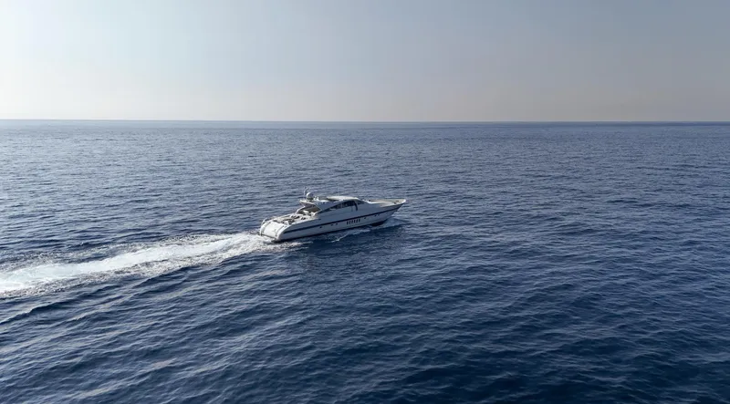  Yacht Photos Pics A 1999 Leopard 27 yacht cruising on open sea under clear skies.