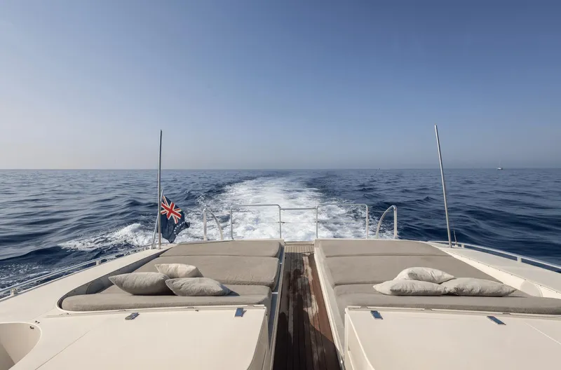  Yacht Photos Pics Luxury yacht Leopard 27 cruising on open sea, 1999 model, with sunbeds and ocean view.