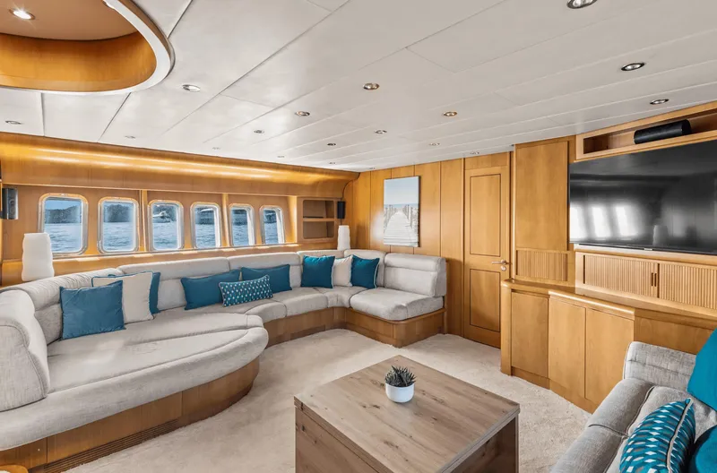  Yacht Photos Pics Luxurious yacht interior with plush seating, wooden accents, and large windows, Leopard 27, 1999 model.