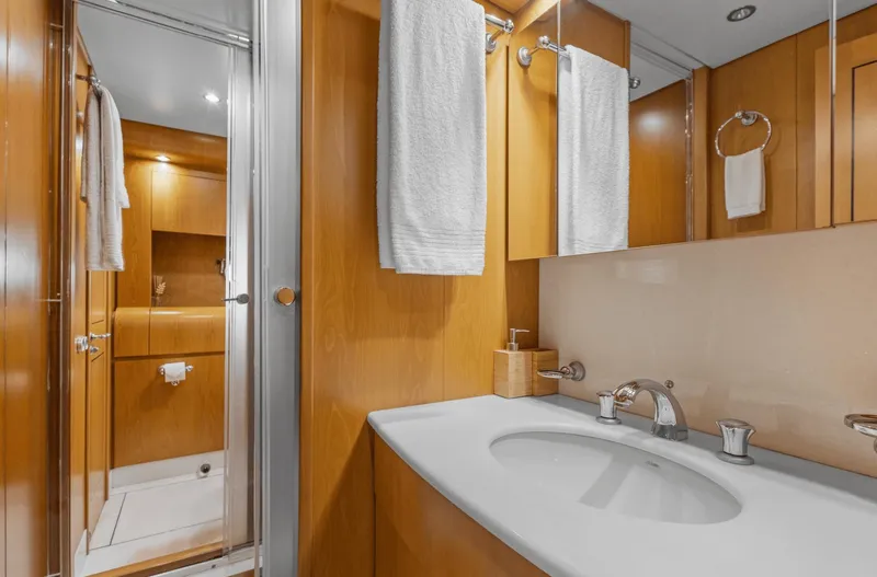  Yacht Photos Pics Luxurious bathroom in 1999 Leopard 27 yacht with wooden cabinetry and modern fixtures.