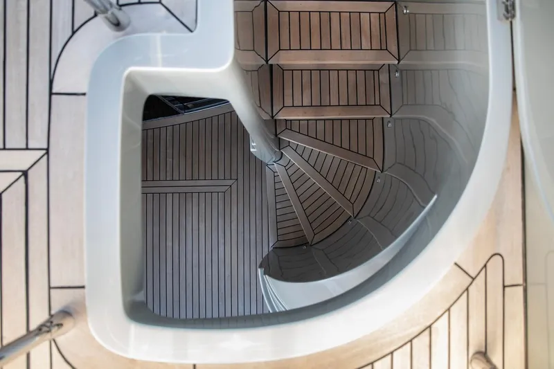  Yacht Photos Pics Spiral staircase on 2009 Canados 110 yacht with elegant wooden design.
